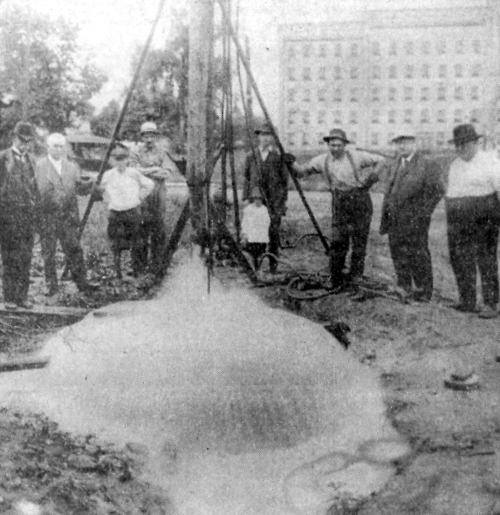 Waterloo Public Utilities Commission and town officials tapping an artesian well on Caroline Street, 1919.