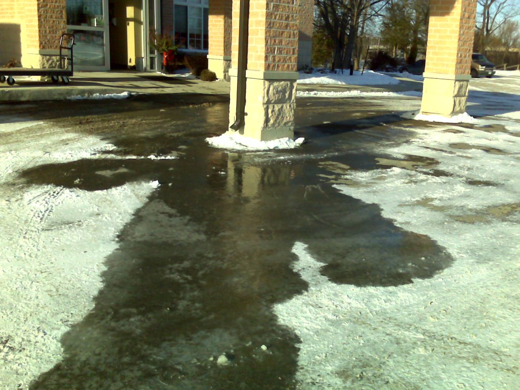 rain from downspout draining on to parking lot