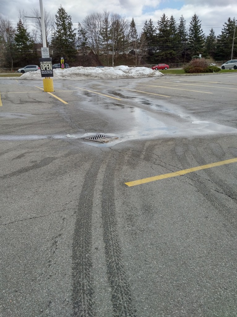 snow pile melting across parking lot