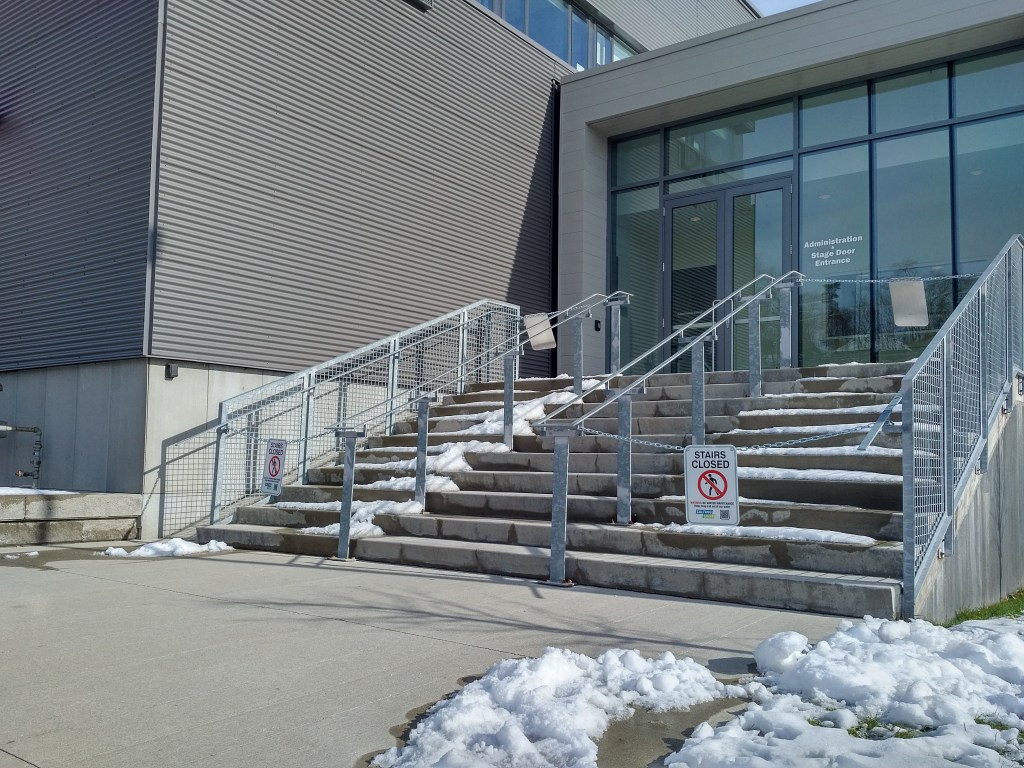 3 sets of stairs with two sets closed off.