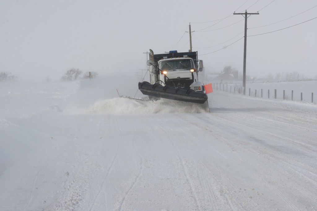 snowplow on rural road plowing snow off road
